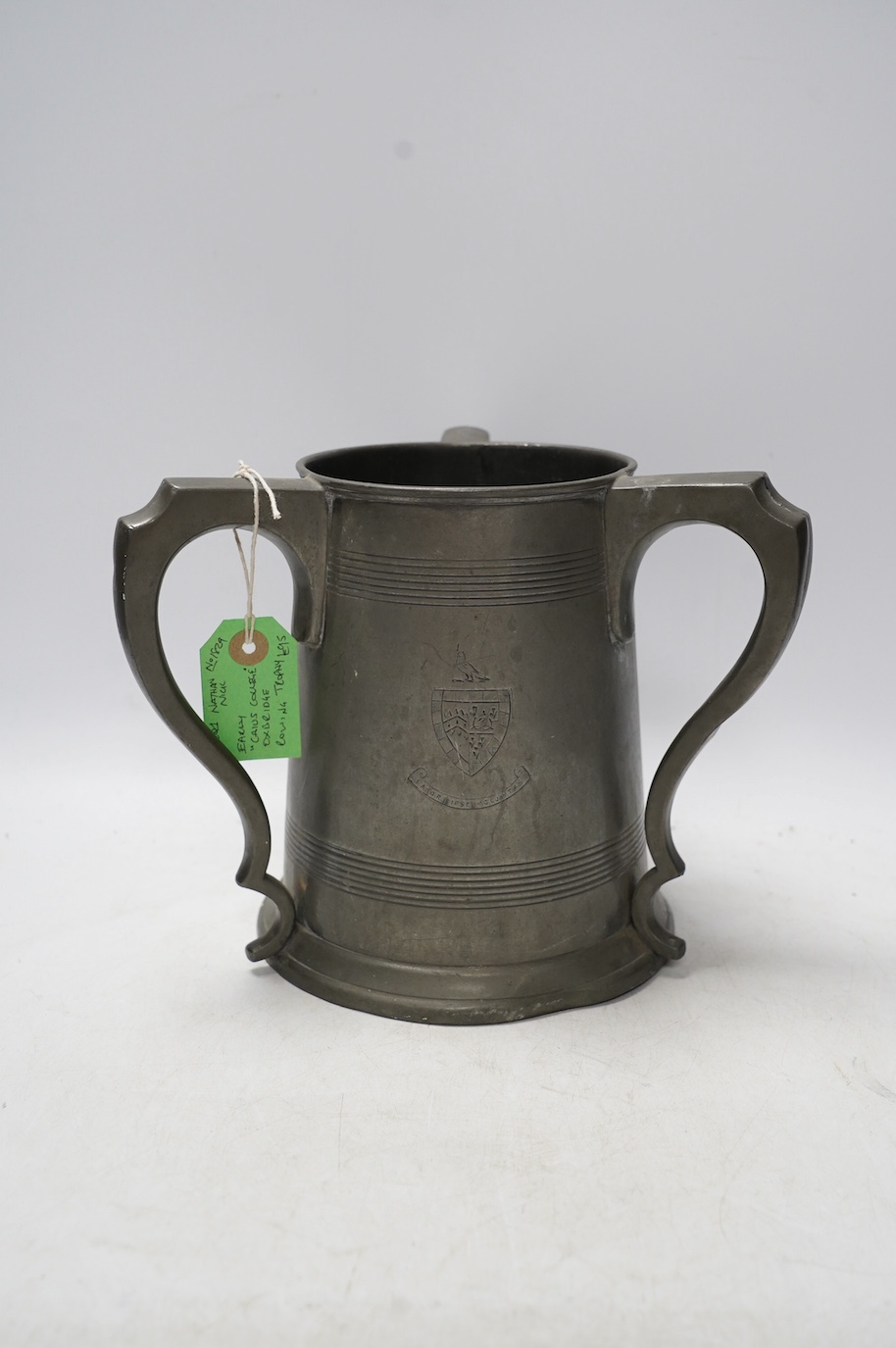 A 19th century pewter three handled rowing trophy from Caius College, 19cm. Condition - fair